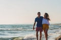 Happy Romantic Middle Aged Couple Enjoying Beautiful Sunset Walk on the Beach Royalty Free Stock Photo