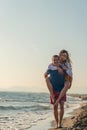 Happy Romantic Middle Aged Couple Enjoying Beautiful Sunset Walk on the Beach Royalty Free Stock Photo