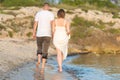 Happy Romantic Middle Aged Couple Enjoying Beautiful Sunset Walk on the Beach Royalty Free Stock Photo