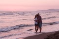 Happy Romantic Middle Aged Couple Enjoying Beautiful Sunset Walk on the Beach. Travel Vacation Retirement Lifestyle Royalty Free Stock Photo