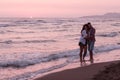 Happy Romantic Middle Aged Couple Enjoying Beautiful Sunset Walk on the Beach. Travel Vacation Retirement Lifestyle Royalty Free Stock Photo