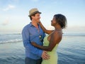 Happy and romantic mixed race couple with attractive black African American woman and Caucasian man playing on beach having fun Royalty Free Stock Photo