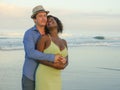 Happy and romantic mixed race couple with attractive black African American woman and Caucasian man playing on beach having fun Royalty Free Stock Photo