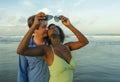 Happy and romantic mixed race couple with attractive black African American woman and Caucasian man playing on beach having fun Royalty Free Stock Photo