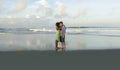 Happy and romantic mixed race couple with attractive black African American woman and Caucasian man playing on beach having fun Royalty Free Stock Photo