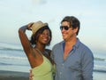 Happy and romantic mixed race couple with attractive black afro American woman and white man playing on beach having fun enjoying Royalty Free Stock Photo