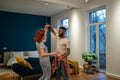 Happy romantic multiracial young couple in love learning to dance together at home Royalty Free Stock Photo