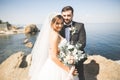 Happy and romantic scene of just married young wedding couple posing on beautiful beach Royalty Free Stock Photo