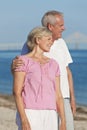 Happy Romantic Senior Couple Embracing on Beach Royalty Free Stock Photo