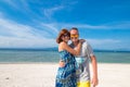 Happy romantic young couple on a beautiful beach with white sand. Caucasian couple having vacation on the tropical Royalty Free Stock Photo