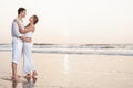 Happy Romantic Young Couple Enjoying Beautiful Sunset on the Beach Royalty Free Stock Photo