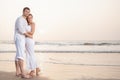 Happy Romantic Young Couple Enjoying Beautiful Sunset on the Beach Royalty Free Stock Photo