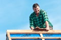 Happy roofer laying tile