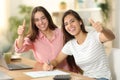 Happy roommates signing form with thumbs up Royalty Free Stock Photo