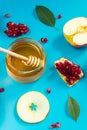 Happy Rosh Hashanah. Pattern from apples, honey and pomegranates on blue background. Jewish traditional religious holiday Royalty Free Stock Photo