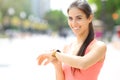 Happy runner checking smartwatch looking at you Royalty Free Stock Photo