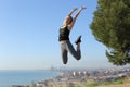 Happy runner jumping celebrating success in ciy outskirts Royalty Free Stock Photo