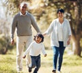 Happy, running and grandparents with child in park for playing, love and support. Care, smile and freedom with family Royalty Free Stock Photo