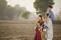 Happy rural Indian family on agricultural field Royalty Free Stock Photo