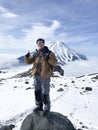 Man shows thumbs up standing on Avachinsky volcano