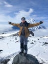 Happy russian man stands on volcano