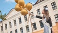 Happy Russian schoolgirl on the last day of school with balloons.