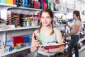 teenager buying different products in stationery shop