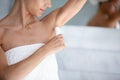 Woman applies antiperspirant after showering in the morning closeup image