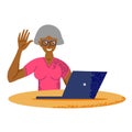 An elderly woman at the computer smiles and waves. Royalty Free Stock Photo