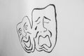 Happy and sad face, theater symbols, drawn on a wall