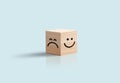 Happy and sad Face In Wooden Cube Business concept. Blue background. Positive negative feedback, customer review. Royalty Free Stock Photo