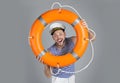 Happy sailor with orange ring buoy on grey