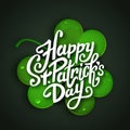 Happy Saint Patrick's Day vector illustration, handwritten brush pen lettering on green realistic shamrock leaf