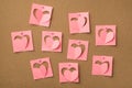 Happy saint valentines day concept. Photo of pastel pink stickers with cut hearts attached to the wooden board with pins Royalty Free Stock Photo