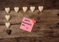 Happy Saint valentines day with post it note and heart shaped chocolate frame on wooden table Royalty Free Stock Photo