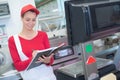 Happy saleswoman weighing meat at supermarket