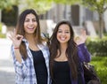 Happy Same-Sex Mixed Race Couple on School Campus With Okay Sign