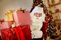 Happy Santa Claus brought many giftboxes to children. New year and Merry Christmas holidays concept