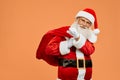 Happy Santa Claus carrying on big red bag full of presents Royalty Free Stock Photo