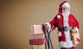 A happy Santa Claus delivering presents with trolley in a postal theme with a plain background and copy space Royalty Free Stock Photo