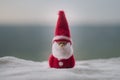 Happy Santa Claus Doll on Christmas time with tree and snow. Blurred outdoor background. Santa Clause and Merry Christmas model fi Royalty Free Stock Photo