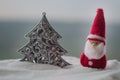 Happy Santa Claus Doll on Christmas time with tree and snow. Blurred outdoor background. Santa Clause and Merry Christmas model fi Royalty Free Stock Photo