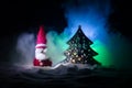 Happy Santa Claus Doll on Christmas time with tree and snow. Colorful bokeh background. Santa Clause and Merry Christmas model fig Royalty Free Stock Photo
