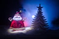 Happy Santa Claus Doll on Christmas time with tree and snow. Colorful bokeh background. Santa Clause and Merry Christmas model fig Royalty Free Stock Photo