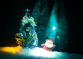 Happy Santa Claus Doll on Christmas time with tree and snow. Colorful bokeh background. Santa Clause and Merry Christmas model fig Royalty Free Stock Photo