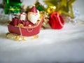 Happy Santa Claus with gifts box on the snow sled the background is Christmas decor.Santa Claus and Christmas decor on the snow. Royalty Free Stock Photo