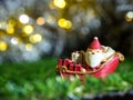 Happy Santa Claus with gifts box on the snow sled going to house. near house have Snowman and Christmas Tree. Santa Claus Royalty Free Stock Photo