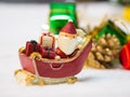 Happy Santa Claus with gifts box on the snow sled the background is Christmas decor.Santa Claus and Christmas decor on the snow. Royalty Free Stock Photo