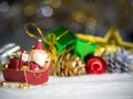 Happy Santa Claus with gifts box on the snow sled going to house. near house have Snowman and Christmas Tree. Santa Claus Royalty Free Stock Photo