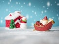 Happy Santa Claus with gifts box on the snow sled going to snow house. near snow house have Snowman and Christmas Tree. Royalty Free Stock Photo
